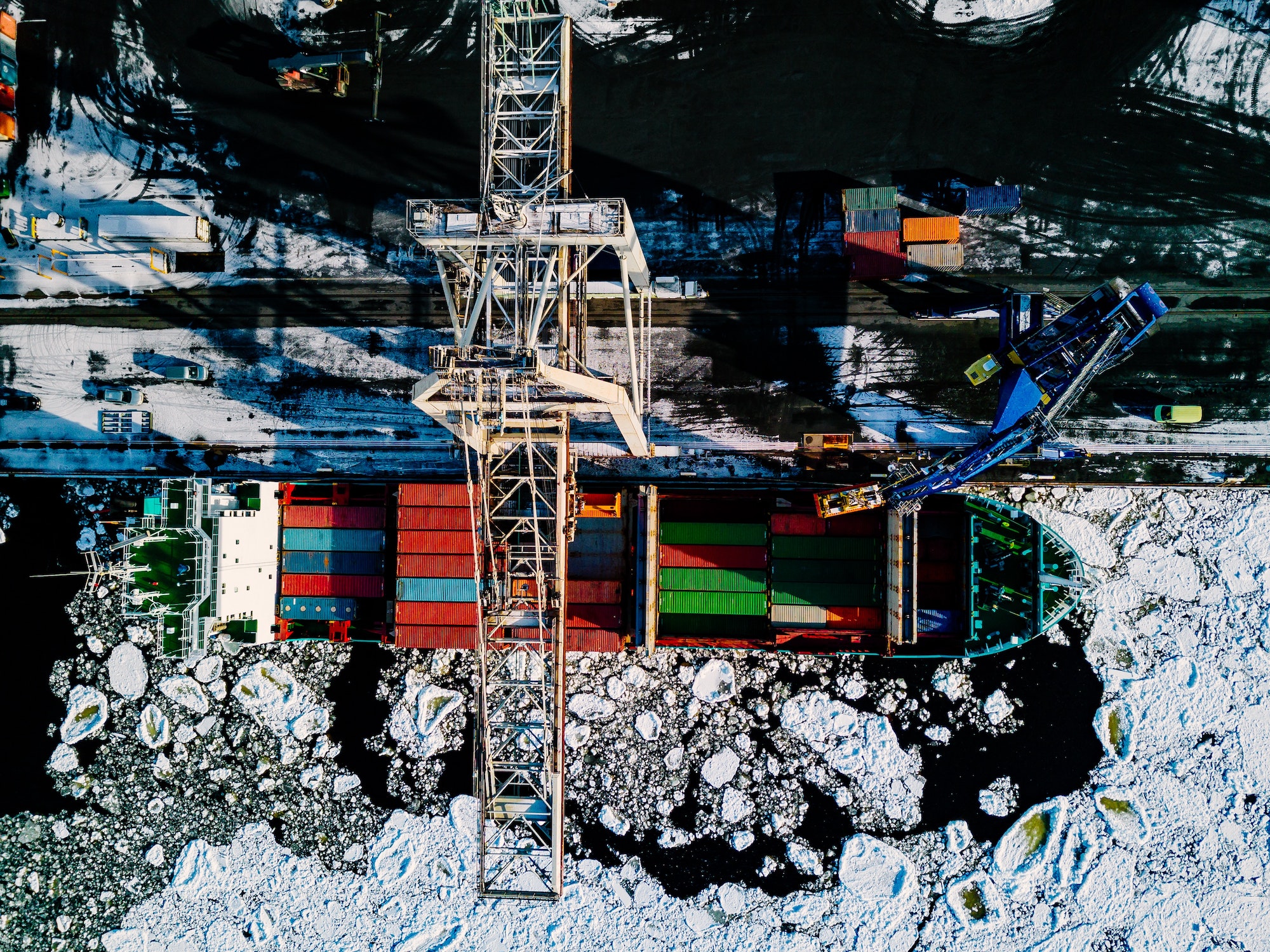 Industrial port with containers in winter, vessel loading